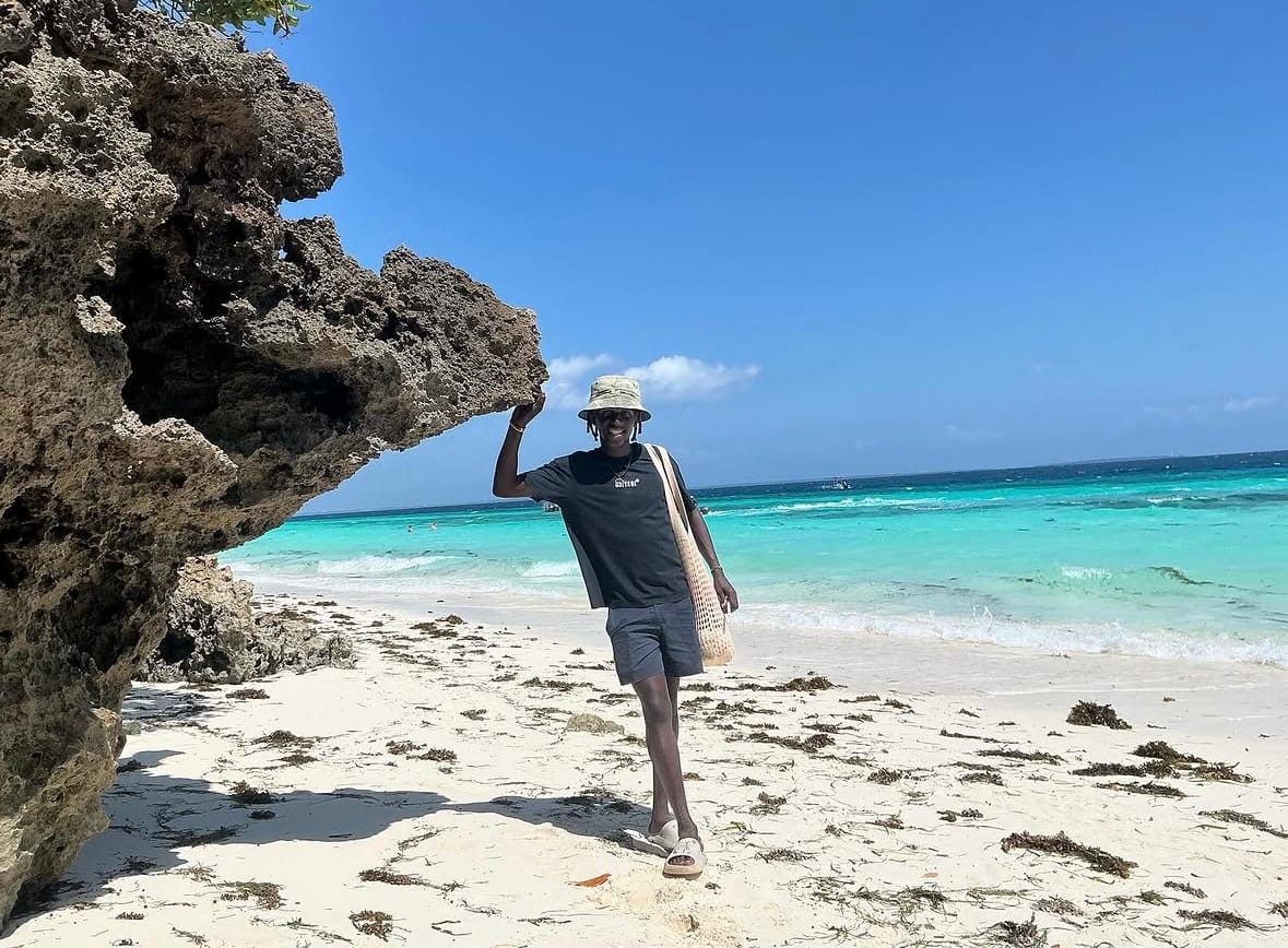 Rama on a Zanzibar beach beneath a coral rock arch